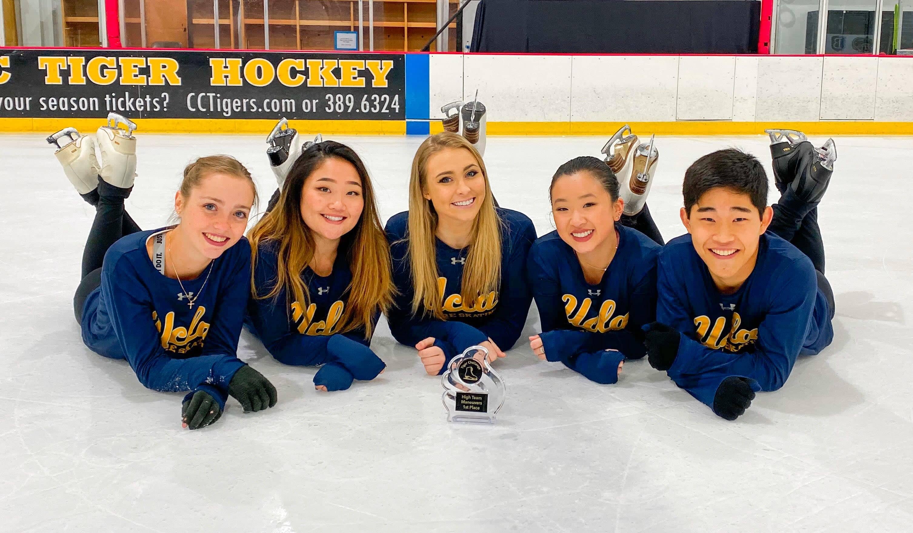 Skaters pose for a picture at a collegiate skating event.